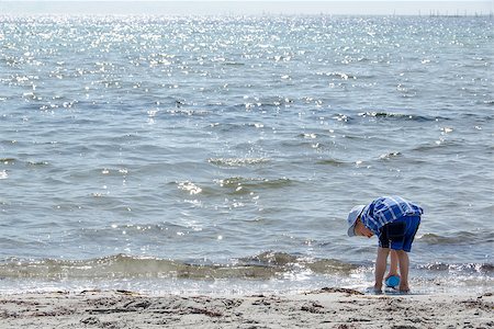 simsearch:400-04423521,k - Boy playing with sand and water at the beach of Denmark Photographie de stock - Aubaine LD & Abonnement, Code: 400-07213776