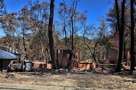 After the fire.   Bushfire destroys homes and vehicles in a random pattern while some are spared completely, others are razed to the ground. Stock Photo - Budget Royalty-Free & Subscription, Code: 400-07213937
