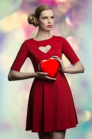 portrait of romantic blonde woman with creative hair-style and red sexy dress taking in the hands one  box of chocolates Stock Photo - Budget Royalty-Free & Subscription, Code: 400-07224146