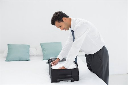 simsearch:693-07672717,k - Side view of a businessman unpacking luggage at a hotel bedroom Stock Photo - Budget Royalty-Free & Subscription, Code: 400-07228446