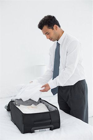 simsearch:693-07672717,k - Side view of a businessman unpacking luggage at a hotel bedroom Stock Photo - Budget Royalty-Free & Subscription, Code: 400-07228451