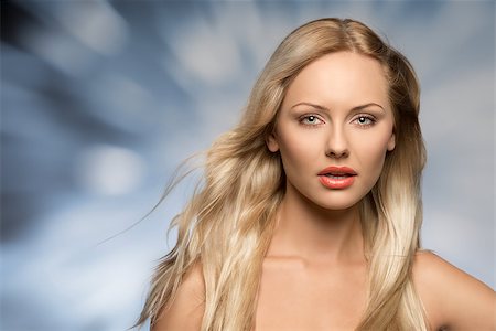 attractive blonde woman in close-up portrait posing with long flying silky hair and perfect skin. Looking in camera Stock Photo - Budget Royalty-Free & Subscription, Code: 400-07223573