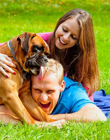 romantic licking photos - Happy Young Couple Playing with their Dog in the Park. Stock Photo - Budget Royalty-Free & Subscription, Code: 400-07223886