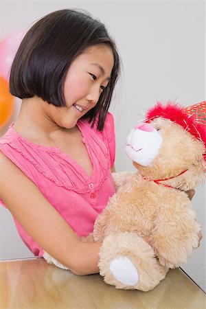 Close-up of cute little girl with her soft toy at a birthday party Stock Photo - Budget Royalty-Free & Subscription, Code: 400-07230139