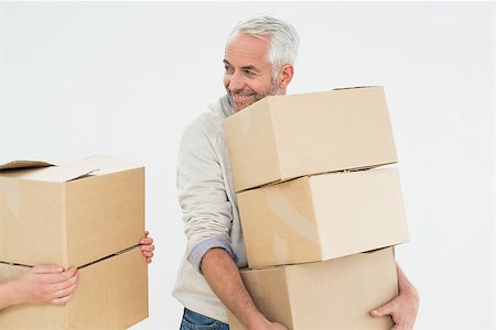 simsearch:400-07930718,k - Smiling mature man carrying boxes against white background Stock Photo - Budget Royalty-Free & Subscription, Code: 400-07230866