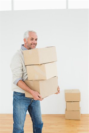 simsearch:400-07930718,k - Smiling mature man carrying boxes in a new house Stock Photo - Budget Royalty-Free & Subscription, Code: 400-07230869