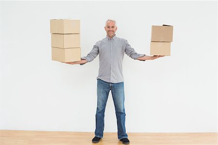 simsearch:400-07930718,k - Portrait of a smiling mature man carrying boxes in a new house Stock Photo - Budget Royalty-Free & Subscription, Code: 400-07230883