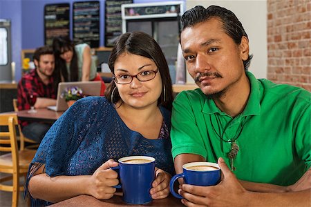 simsearch:400-06396543,k - Grinning Latino and Asian couple in cafe Stock Photo - Budget Royalty-Free & Subscription, Code: 400-07244057