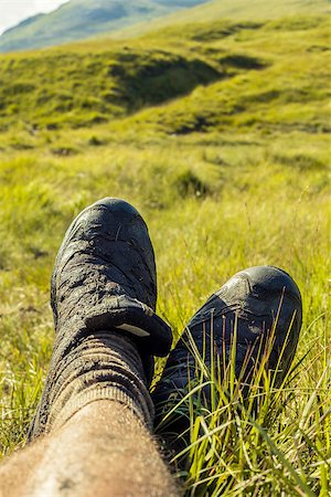 Taking a rest after a hike through a wet, muddy grassfield Stock Photo - Budget Royalty-Free & Subscription, Code: 400-07247481