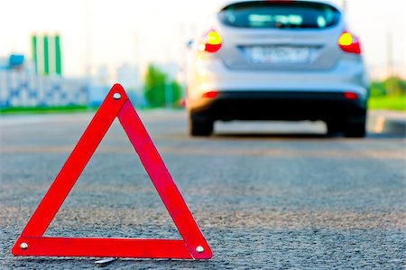warning triangle on the road and the car moved down to the curb Stock Photo - Budget Royalty-Free & Subscription, Code: 400-07252683
