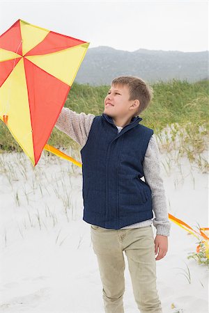 Happy young boy looking at kite at the beach Stock Photo - Budget Royalty-Free & Subscription, Code: 400-07267304