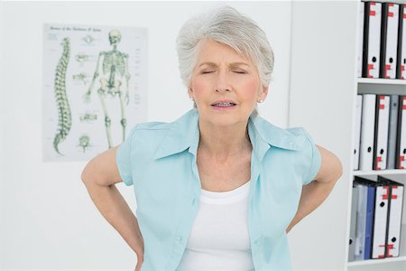 Senior woman with back pain standing in the medical office Stock Photo - Budget Royalty-Free & Subscription, Code: 400-07267708