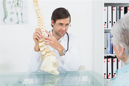 Male doctor explaining the spine to a senior patient in medical office Stock Photo - Budget Royalty-Free & Subscription, Code: 400-07267745