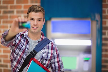 simsearch:400-05670021,k - Student showing his card to camera at the atm in college Stock Photo - Budget Royalty-Free & Subscription, Code: 400-07268049