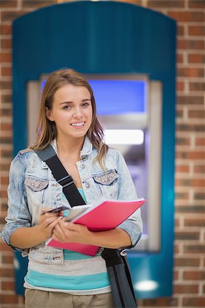 simsearch:400-05670020,k - Student standing smiling at camera at the atm in college Stock Photo - Budget Royalty-Free & Subscription, Code: 400-07268051
