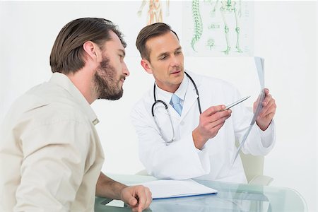 Male doctor explaining spine x-ray to patient in the medical office Stock Photo - Budget Royalty-Free & Subscription, Code: 400-07269206