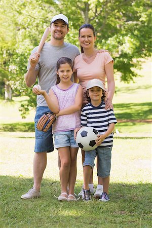 Full length portrait a family of four holding baseball bat and ball in the park Stock Photo - Budget Royalty-Free & Subscription, Code: 400-07275213