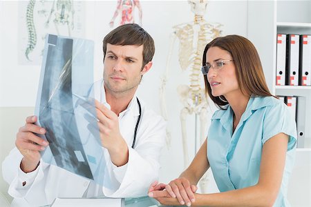 Male doctor explaining spine x-ray to female patient in the medical office Stock Photo - Budget Royalty-Free & Subscription, Code: 400-07270836