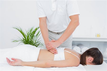 simsearch:400-05352116,k - Male physiotherapist massaging woman's back in the medical office Photographie de stock - Aubaine LD & Abonnement, Code: 400-07271319