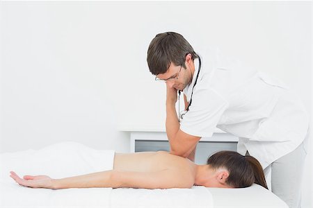 simsearch:400-05352116,k - Male physiotherapist massaging woman's back in the medical office Photographie de stock - Aubaine LD & Abonnement, Code: 400-07271347
