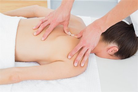 simsearch:400-05352116,k - Close-up of male physiotherapist massaging woman's back in the medical office Photographie de stock - Aubaine LD & Abonnement, Code: 400-07271353