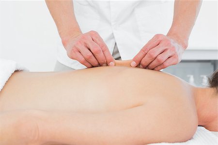 simsearch:400-05352116,k - Close-up mid section of a male physiotherapist massaging woman's back in the medical office Photographie de stock - Aubaine LD & Abonnement, Code: 400-07271385