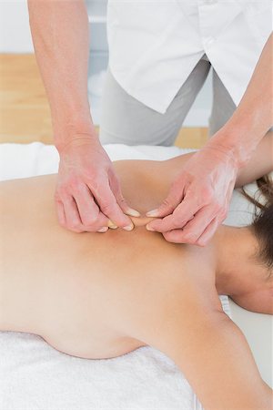 simsearch:400-05352116,k - Close-up of a male physiotherapist massaging woman's back in the medical office Photographie de stock - Aubaine LD & Abonnement, Code: 400-07271402