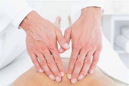 simsearch:400-05352116,k - Close-up of a male physiotherapist massaging woman's back in the medical office Photographie de stock - Aubaine LD & Abonnement, Code: 400-07271455