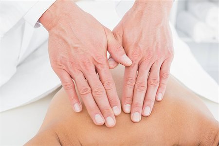 simsearch:400-05352116,k - Close-up of a male physiotherapist massaging woman's back in the medical office Photographie de stock - Aubaine LD & Abonnement, Code: 400-07271452