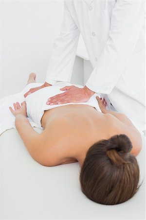 simsearch:400-05352116,k - Male physiotherapist massaging woman's back in the medical office Photographie de stock - Aubaine LD & Abonnement, Code: 400-07271475