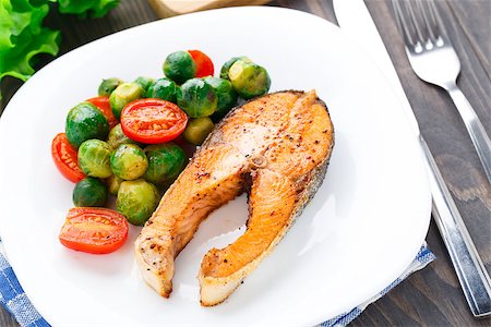 Salmon with roasted brussels sprout and tomato on a plate Stock Photo - Budget Royalty-Free & Subscription, Code: 400-07295466