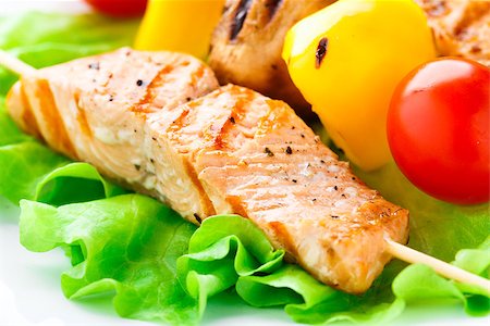 Grilled salmon on bamboo sticks and vegetable skewers with lettuce Stock Photo - Budget Royalty-Free & Subscription, Code: 400-07295474