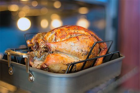 Turkey Cooked Brined and Seasoned with Spices in Roasting Pan for Thanksgiving Dinner with Blurred Oven Background Stock Photo - Budget Royalty-Free & Subscription, Code: 400-07295839
