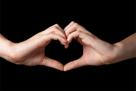 female teen hands showing heart symbol, isolated on black Stock Photo - Budget Royalty-Free & Subscription, Code: 400-07296289