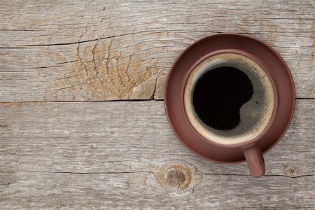 simsearch:400-07305144,k - Coffee cup on wooden table texture. View from above Stock Photo - Budget Royalty-Free & Subscription, Code: 400-07299274