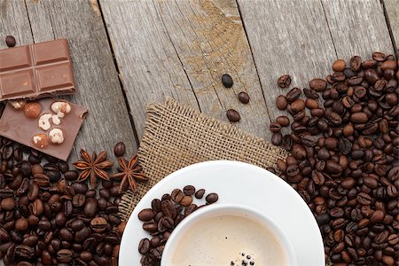 simsearch:400-07305144,k - Coffee cup and chocolate on wooden table texture with copy space. View from above Stock Photo - Budget Royalty-Free & Subscription, Code: 400-07299270