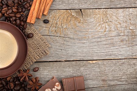 simsearch:400-07305144,k - Coffee cup, spices and chocolate on wooden table texture with copy space. View from above Stock Photo - Budget Royalty-Free & Subscription, Code: 400-07299271