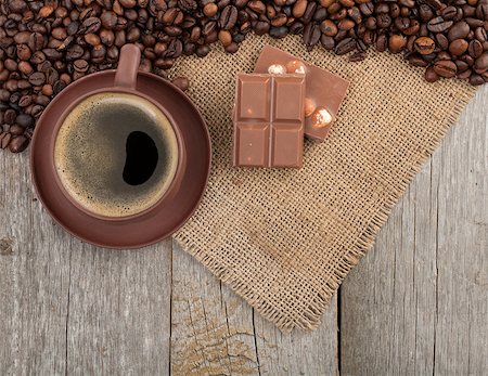 simsearch:400-07305144,k - Coffee cup and chocolate on wooden table texture with copy space. View from above Stock Photo - Budget Royalty-Free & Subscription, Code: 400-07299273