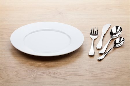 setting kitchen table - Empty white plate with silverware on wooden table Stock Photo - Budget Royalty-Free & Subscription, Code: 400-07299424