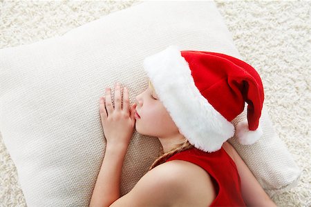 santa children - portrait of a sleeping  girl in a Santa hat Stock Photo - Budget Royalty-Free & Subscription, Code: 400-07290806