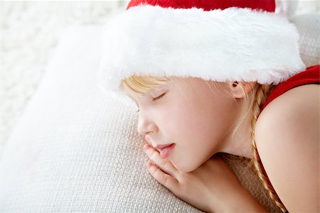santa children - portrait of a sleeping girl in a Santa hat Stock Photo - Budget Royalty-Free & Subscription, Code: 400-07290801