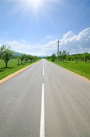 simsearch:400-05112302,k - asphalt road runs along with the markings of green meadows Stock Photo - Budget Royalty-Free & Subscription, Code: 400-07293546