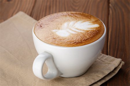 simsearch:400-07305144,k - freshly made cup of cappuccino with leaf art, on wooden table Stock Photo - Budget Royalty-Free & Subscription, Code: 400-07304080