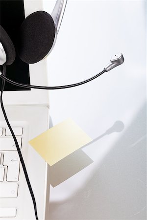 headset keyboard notebook laptop in office on table desk closeup objects Stock Photo - Budget Royalty-Free & Subscription, Code: 400-07304870