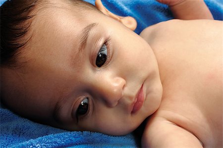 simsearch:400-05153083,k - happy baby resting on a blue towel Stock Photo - Budget Royalty-Free & Subscription, Code: 400-07305534