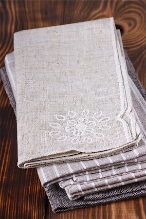 setting kitchen table - Pile of linen table napkins on a wooden background. Stock Photo - Budget Royalty-Free & Subscription, Code: 400-07300163