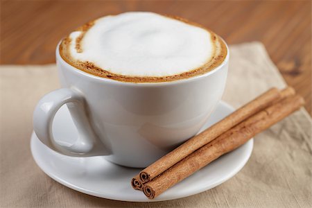 simsearch:400-07305144,k - cup of fresh hot cappuccino with cinnamon sticks, on wooden table Stock Photo - Budget Royalty-Free & Subscription, Code: 400-07301333