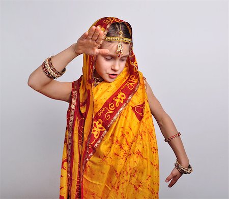 portrait of child in traditional Indian clothing, sari and jeweleries dancing Stock Photo - Budget Royalty-Free & Subscription, Code: 400-07302994