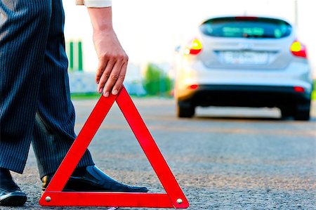 dangerous accident - man sets the warning triangle Stock Photo - Budget Royalty-Free & Subscription, Code: 400-07314727