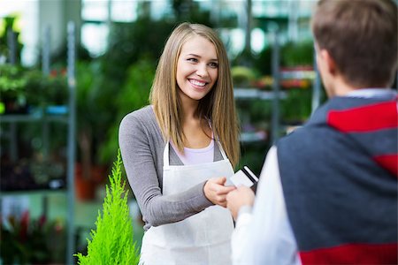 Man giving credit card to the saleswoman Stock Photo - Budget Royalty-Free & Subscription, Code: 400-07315299